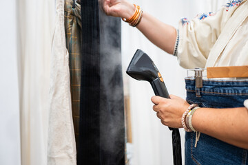 Garment steamer in use at a modern clothing store