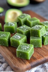 Slices of fresh and tasty avocado cut on wooden board