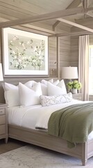 Fototapeta premium A serene bedroom showcases a floral-patterned blanket and cream quilt cover on a neatly made bed, complemented by white pillows and a rustic vintage rug beneath