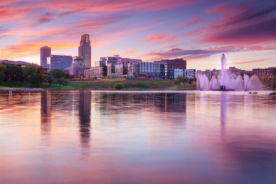 Omaha, Nebraska, USA. Cityscape image of downtown Omaha, Nebraska with reflection of the skyline at beautiful autumn sunset.