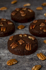 Homemade cookies with pecan nuts on a gray background