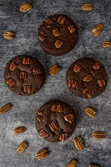 Homemade cookies with pecan nuts on a gray background