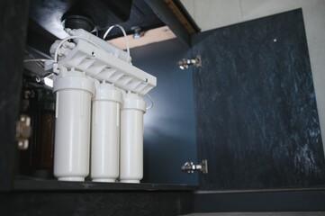 Reverse osmosis water purification system at home. Installed water purification filters. Clear...