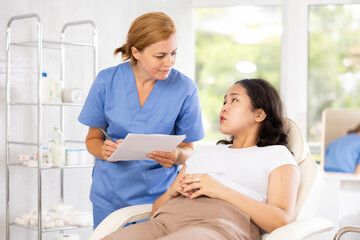 Fototapeta premium Qualified doctor of european appearance providing consulting services to client in clinic