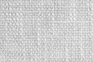 Texture of white jacquard fabric of rough weave, cloth structure background, close up, macro