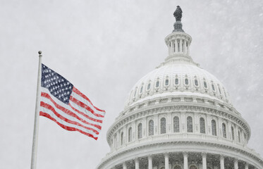 A snow covered Washington D.C. Capitol building with a red and white American flag flying in front of it