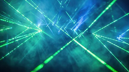 Obraz premium Bright laser lines in green and blue, forming dynamic patterns on a dark, foggy backdrop, adding depth to the visual