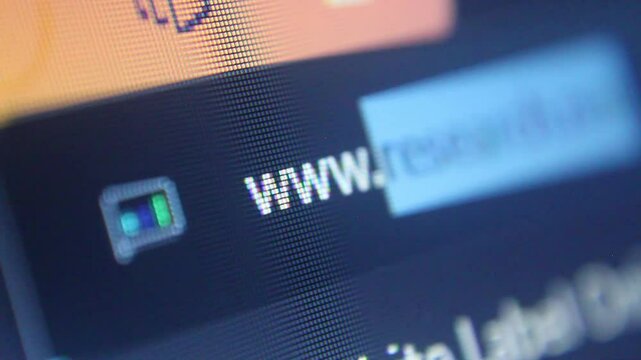 closeup of a screenn showing a typing of a web adress 