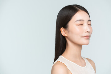 Portrait of a young beautiful Asian woman. She has straight black hair.