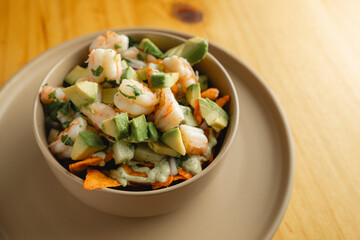 Shrimp and avocado salad beautifully served on a rustic table