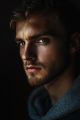 Obraz premium Close-up portrait of a well-dressed handsome man posing and looking at the camera. Model man on dark background studio photo.