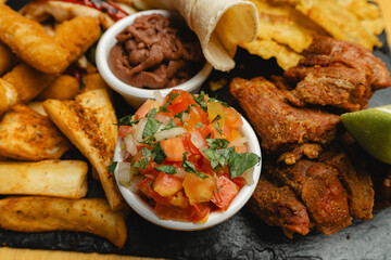 A delicious plate of food is garnished with a bowl of salsa on it