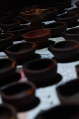 Artistic homemade clay oil lamps or karthikai deepam are ready for diwali and karthikai festivals