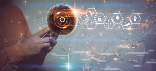 Hand holding smartphone. pressing the power button with the energy resources icon on Earth at night background. Earth day. Environment and conservation. sustainable development. Energy saving concept.