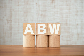 There is wood cube with the word ABW. It is an abbreviation for Activity Based Working as eye-catching image.