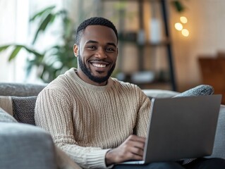 Smiling Man Working on Laptop