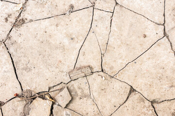Fototapeta premium White black grey wall, floor with cracks, texture background, a hole in the concrete wall