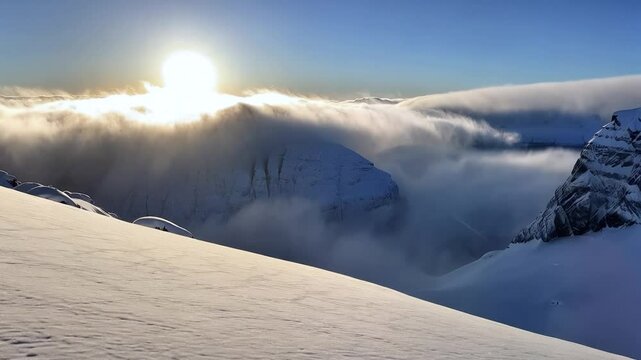 Panoramic view to summit and snow peaks with beautiful sunlight. Scenery view down on snow covered valley.