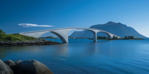 Naklejka premium A stunning white arch bridge stretches across the crystal-clear blue waters, with mountains in the background.