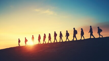 Fototapeta premium Silhouettes of people walking on hill at sunset