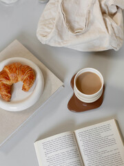Croissant, Coffee, Book, Canvas Bag On Table Setup