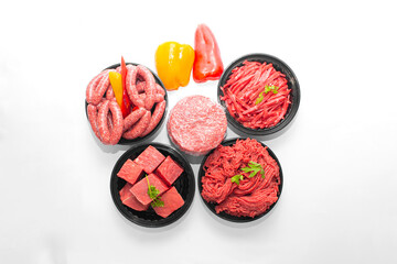 Top View of Assorted Raw Beef Products Sausages, Minced Meat, Burger Patty, Beef Cubes, and Strips Isolated on White Background