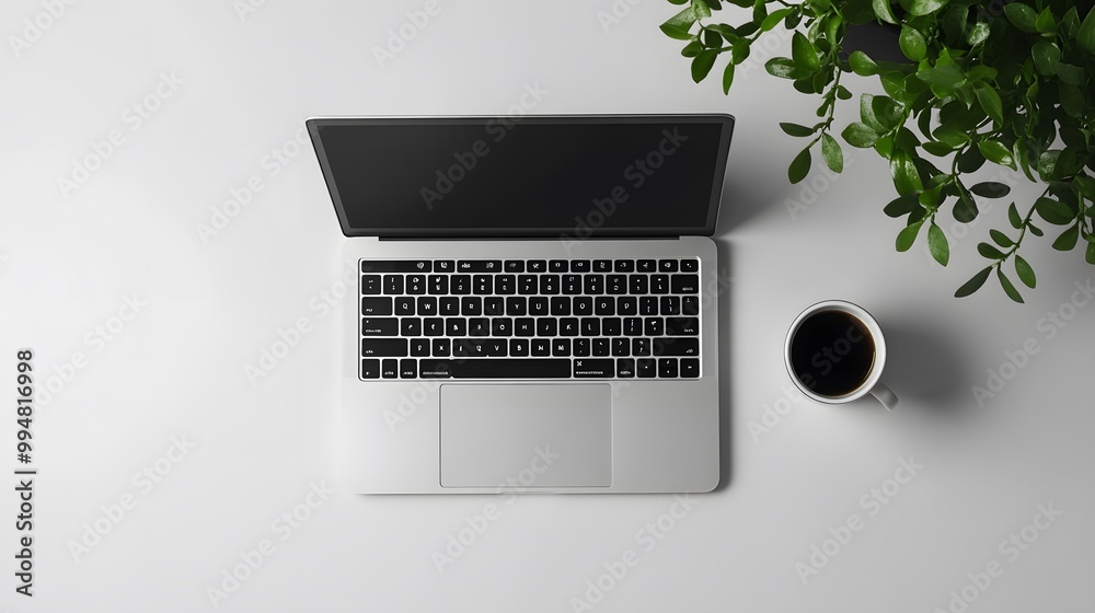 Poster An overhead view of a simple workspace featuring a laptop and a coffee cup, set against a plain backdrop to emphasize its calm and functional design.