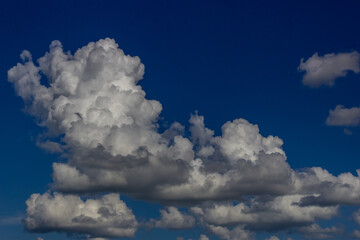 Obraz premium Blue sky background with white clouds. Cumulus white clouds in the blue sky.