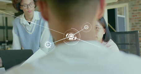 Image of network of connections with globe icons over diverse business people in office