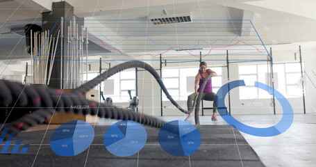Fitness data analysis image over woman exercising with battle ropes in gym