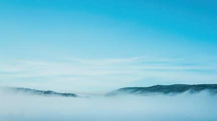 Blue_sky_with_landscape_in_fog