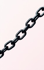 Fototapeta premium Black chain link against a soft pink background, ideal for industrial themes.