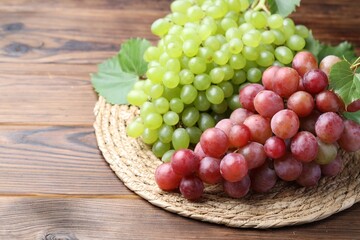 Delicious fresh ripe grapes on wooden table