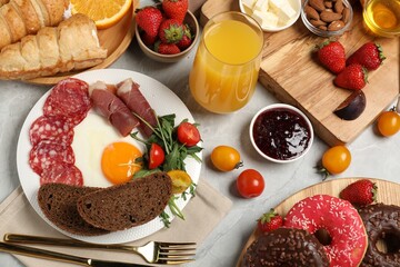 Different tasty food served for brunch on grey marble table, flat lay