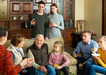 Family meeting. Friendly family enjoying communication with each other in comfy home interior