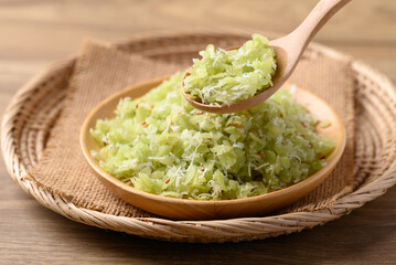 Tradition Thai dessert (Khao Mao), Green pounded unripe rice flakes with sliced coconut and sesame