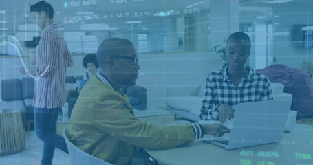 Image of financial data processing over diverse colleagues discussing work in office