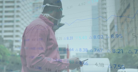 Image of financial data processing over african american man in face mask using smartphone