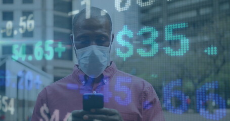 Image of financial data processing over african american man in face mask using smartphone