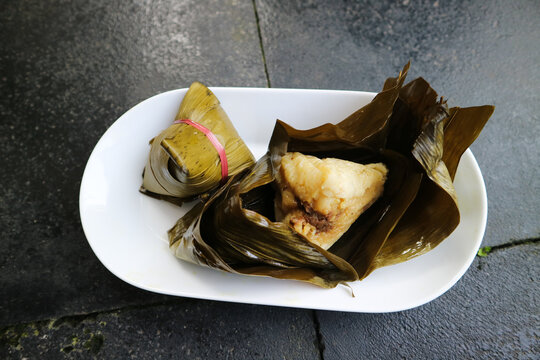 Bacang or bakcang. Chinese savoury sticky rice dumplings in bamboo leaves wrapping.  It contains meat inside the taste very delicious.