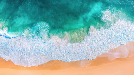 Fototapeta premium Aerial view of turquoise ocean waves hitting the golden sand on beach