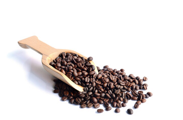 Fresh coffee beans in a wooden spoon.
