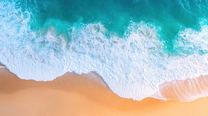 Fototapeta premium Aerial view of turquoise ocean waves hitting the golden sand on beach