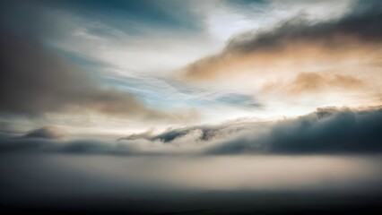 Misty morning sky with low drifting clouds