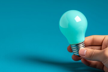 Smooth Aqua Light Bulb in Hand Highlighting a Innovative Concept