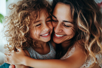 Obraz premium curly-haired daughter kissing her mother’s cheek