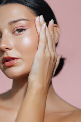 Close-Up of Latina Woman with Radiant Skin and Hand Touching Face