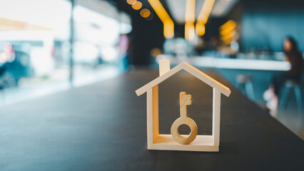 House model and key in home insurance broker agent ‘s hand or in salesman person. Real estate...
