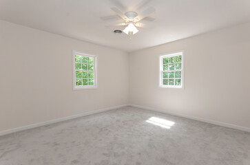 Spacious Empty Room With Two Windows And Ceiling Fan