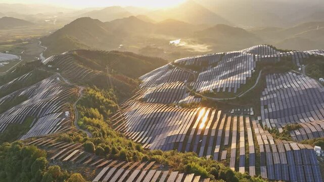 Aerial photography of solar photovoltaic panels，sunset over the mountains